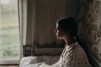 Girl looking out of a window.